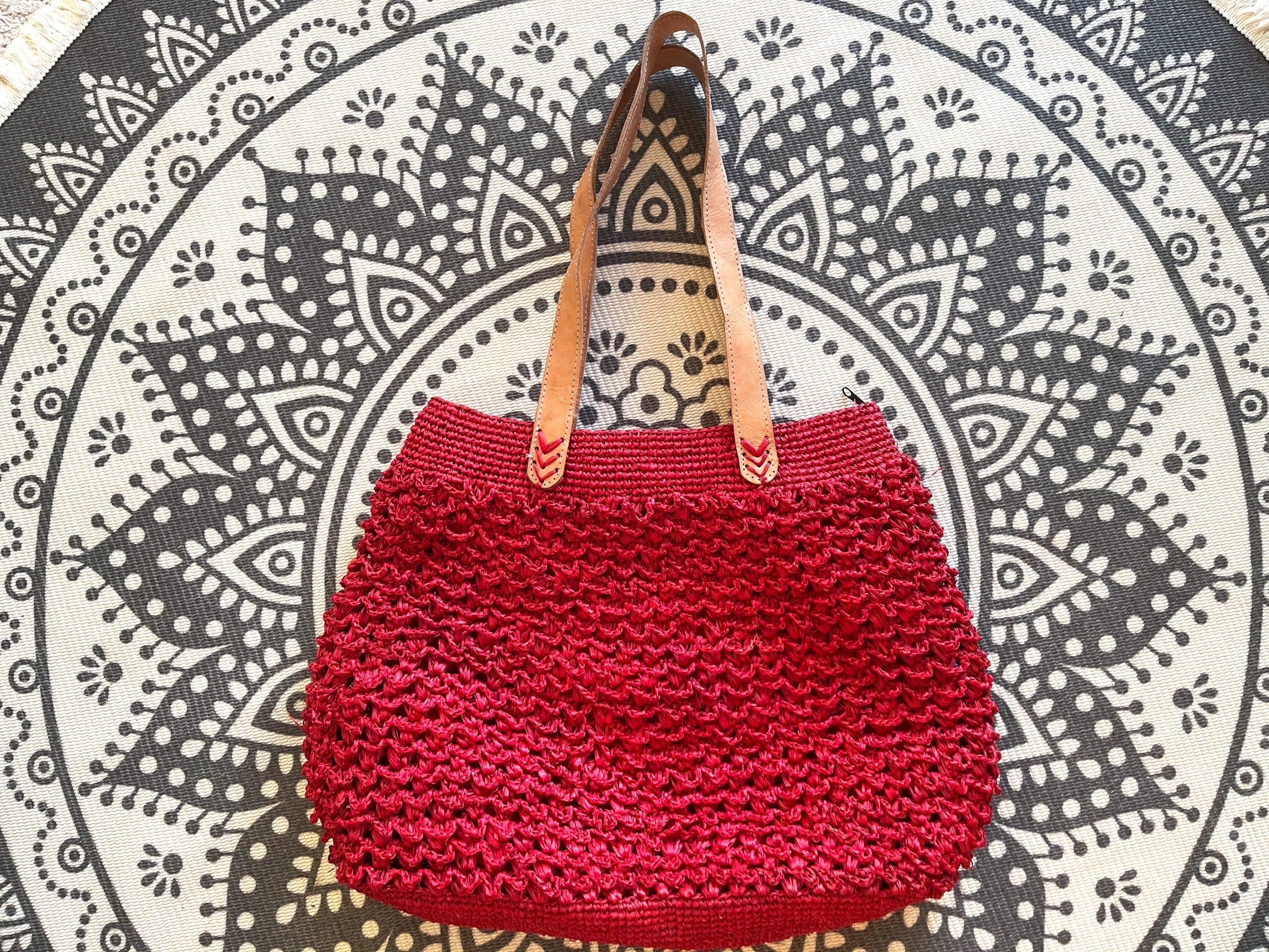 Red handmade crocheted handbag in raffia